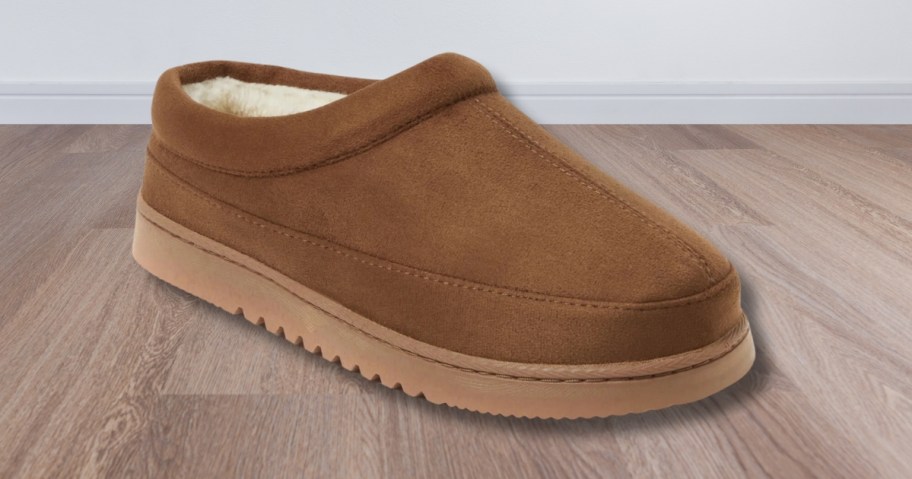 a brown clog style slipper shoe on a wood floor