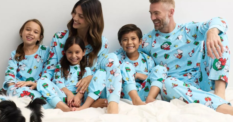 family waring matching Peanuts Christmas pajamas