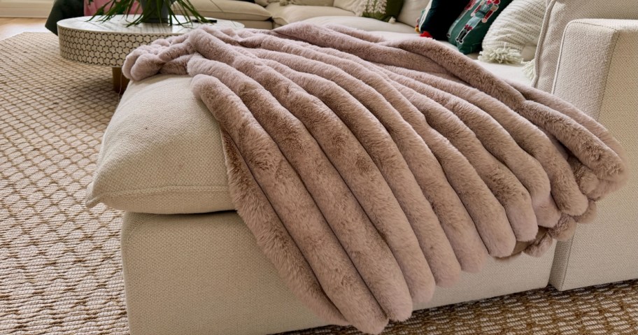 a faux fur throw blanket on a couch
