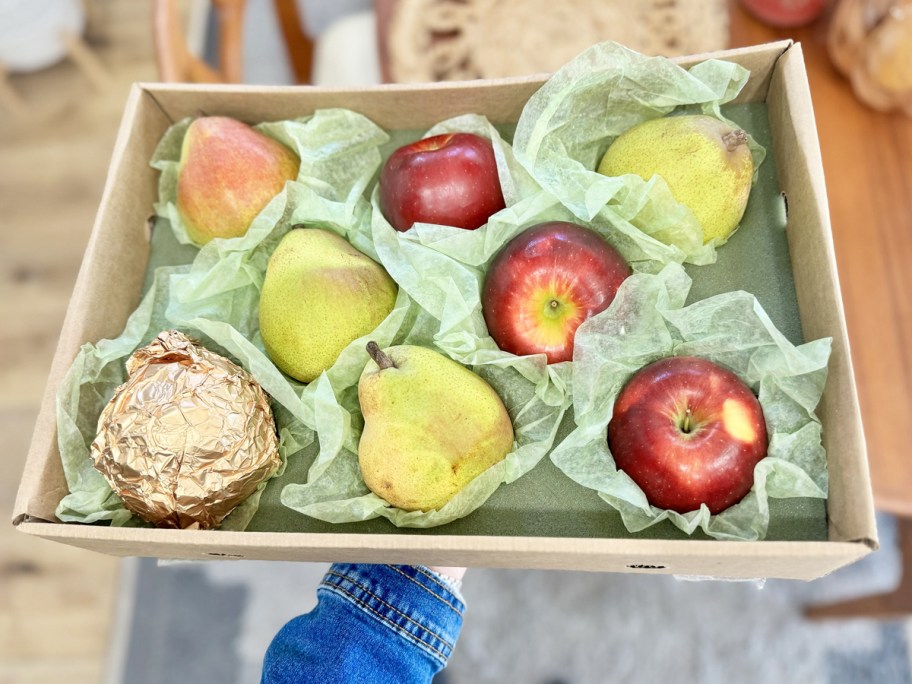 hand under a box of Harry & David Pears & Apples