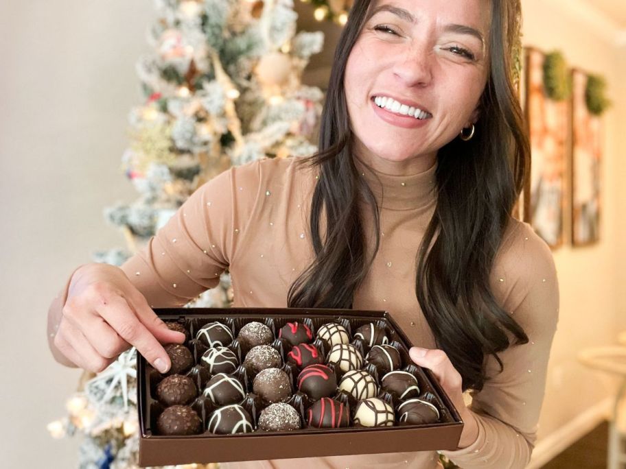 Woman with a box of Harry & David Truffles