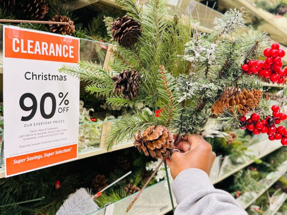 Hand holding a holiday floral pick