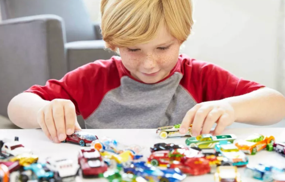 boy playing with Hot Wheels Cars