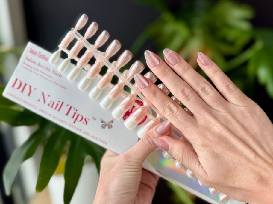 Hand holding a Jofay 160-piece Press on nail set while showing off the nails on the other hand