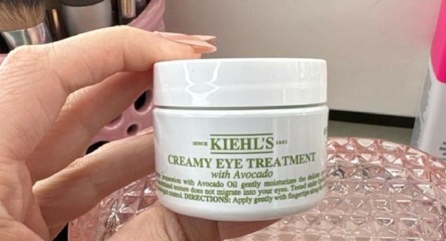 Kiehls creamy eye treatment cream in womans hand