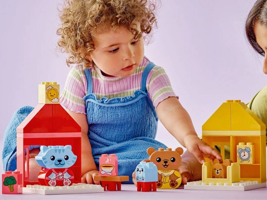 Little girl playing with a LEGO DUPLO My First Daily Routines: Eating & Bedtime