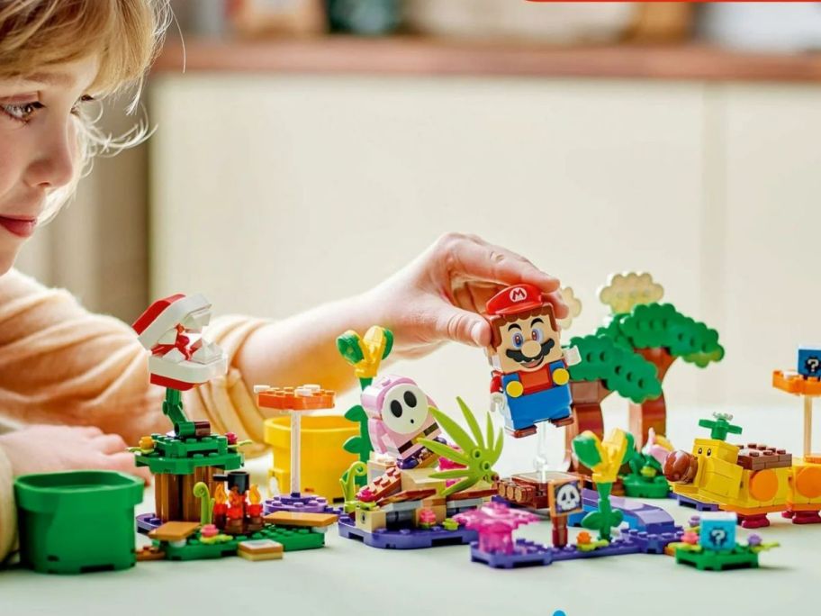 Little girl playing with a LEGO Super Mario Soda Jungle Maker