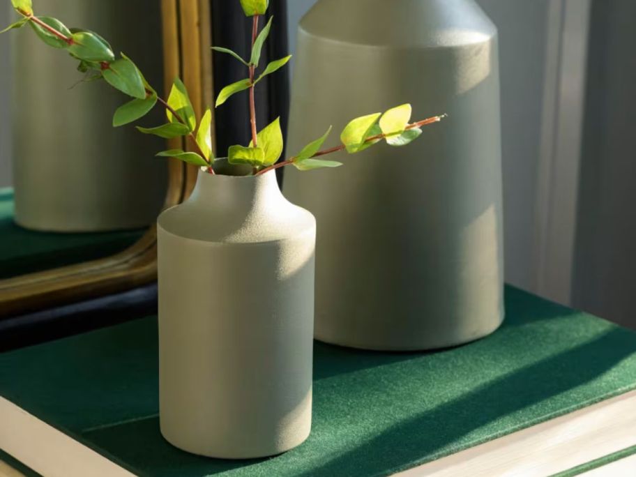 Magnolia Sage Green Carter Vase on table with leaves in it