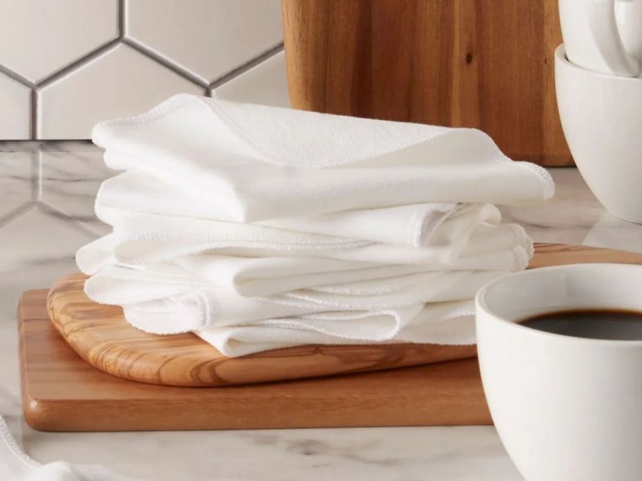 Mainstays Dish Towel 10-Piece Set - White stacked on cutting board in kitchen