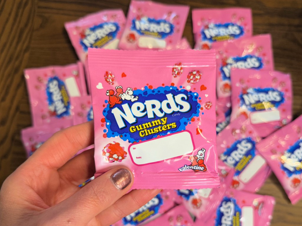 person holding up pink Nerds Gummy Clusters Treat Packs