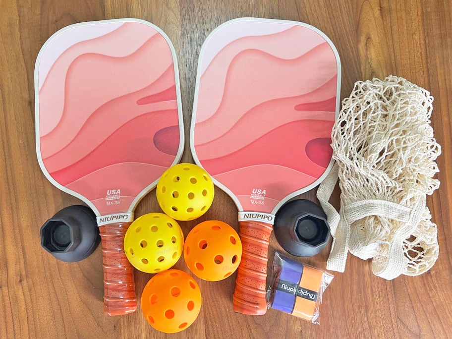 set of pink pickleball paddles, balls, grip tape, and bag