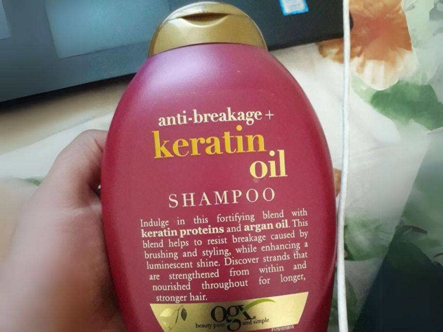 OGX Organix Anti-Breakage Keratin Oil Shampoo bottle in hand