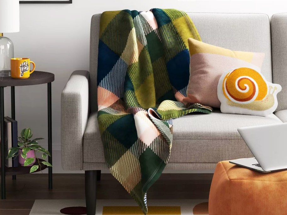 plaid print throw blanket draped over couch