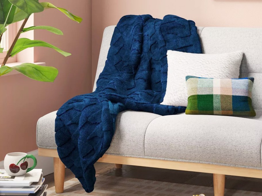 dark blue throw blanket draped over couch