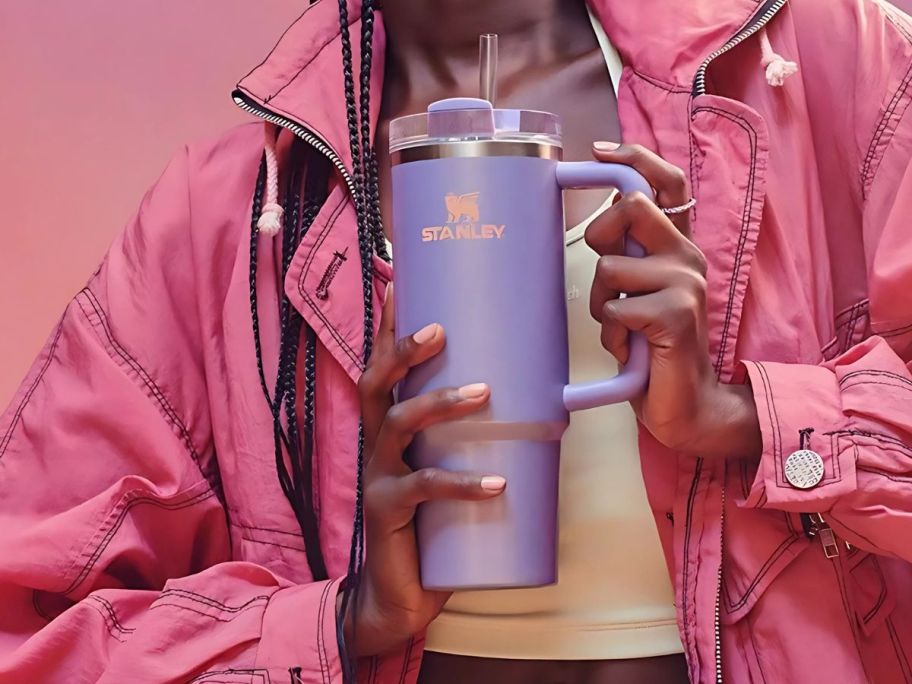 A person holding a Stanley Periwinkle Shimmer Tumbler