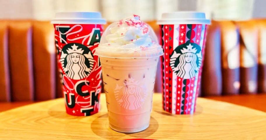 starbucks holiday drinks on wood table