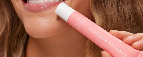 woman holding pink Summer Friday Lip Balm