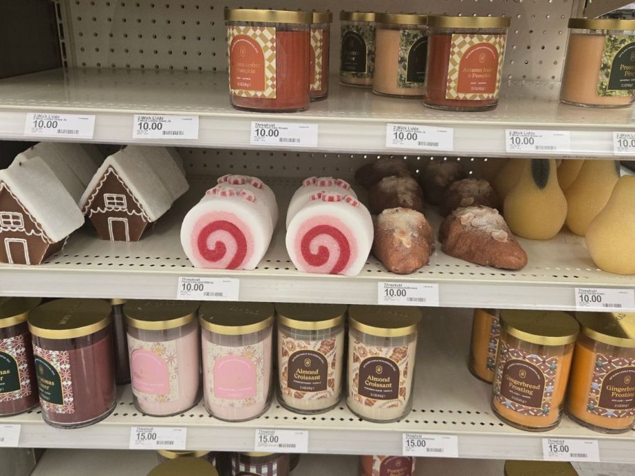 A shelf of Threshold Christmas Jar and Figural Candles