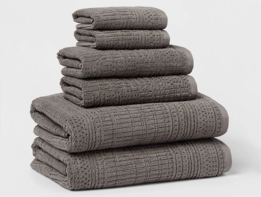 a stack of 6 gray colored towels, hand towels and wash cloths