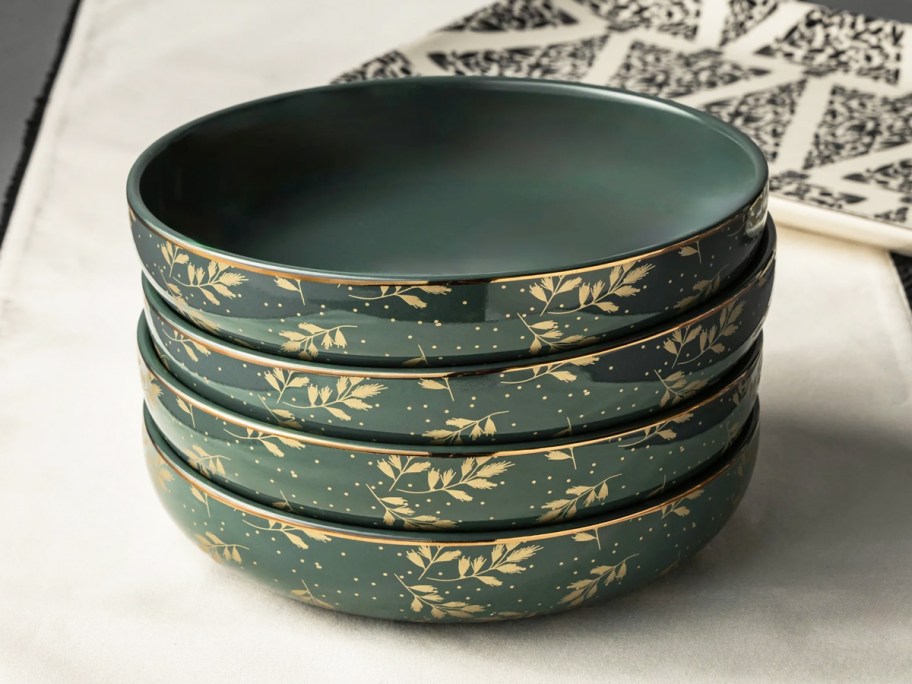 stack of green and gold bowls on table