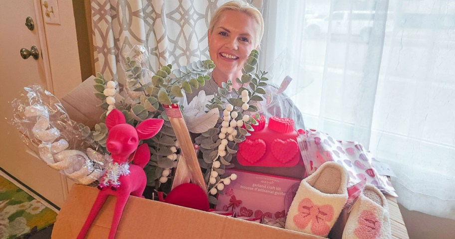 Woman holding box of goods from Michaels in a $10 grab box