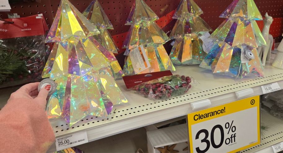 hand holding Wondershop Christmas iridescent tree at the store