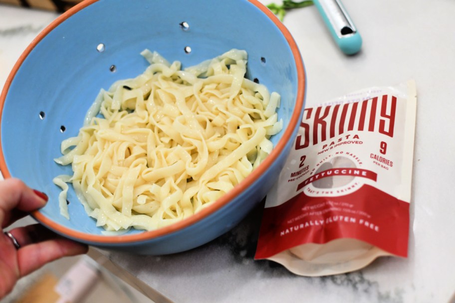 adding skinny noodles to colander 