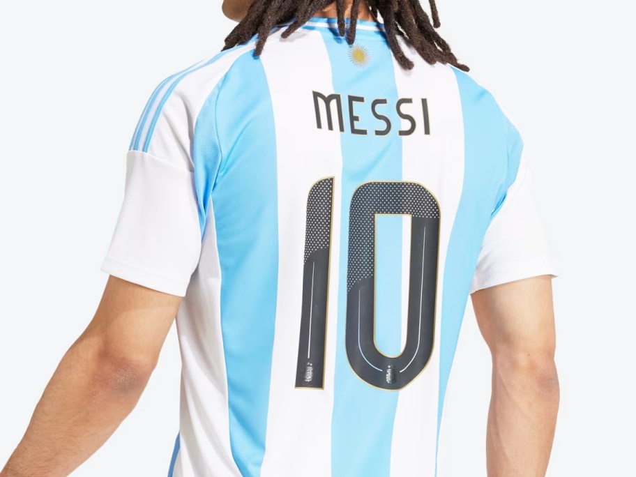 man in white and blue striped Messi soccer jersey