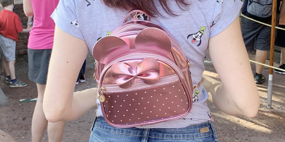 person wearing pink minnie backpack