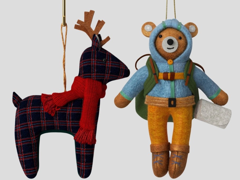 a plaid reign deer ornament and a mountain climbing bear ornament