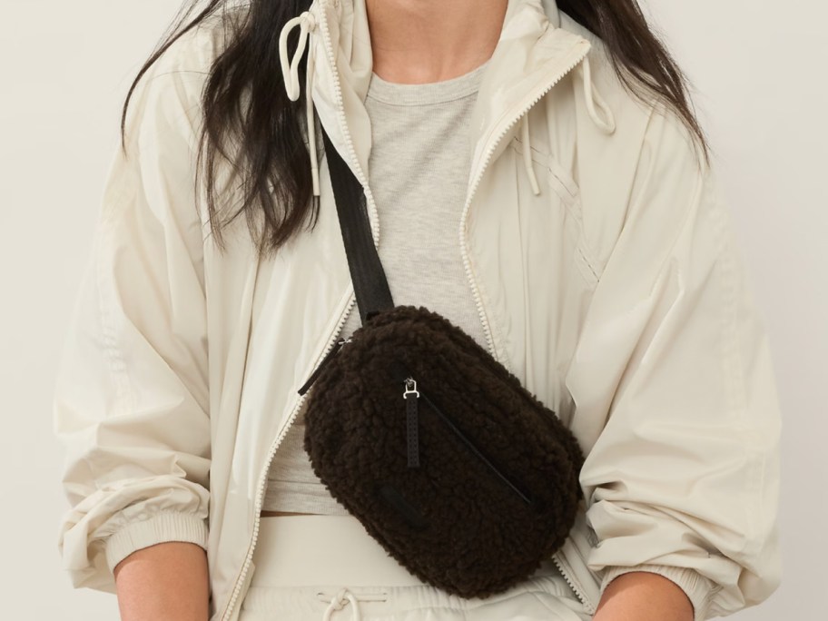 woman with shearling belt bag