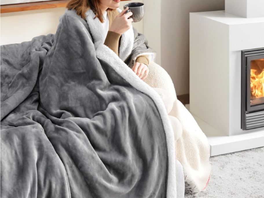woman shown wrapped in gray blanket