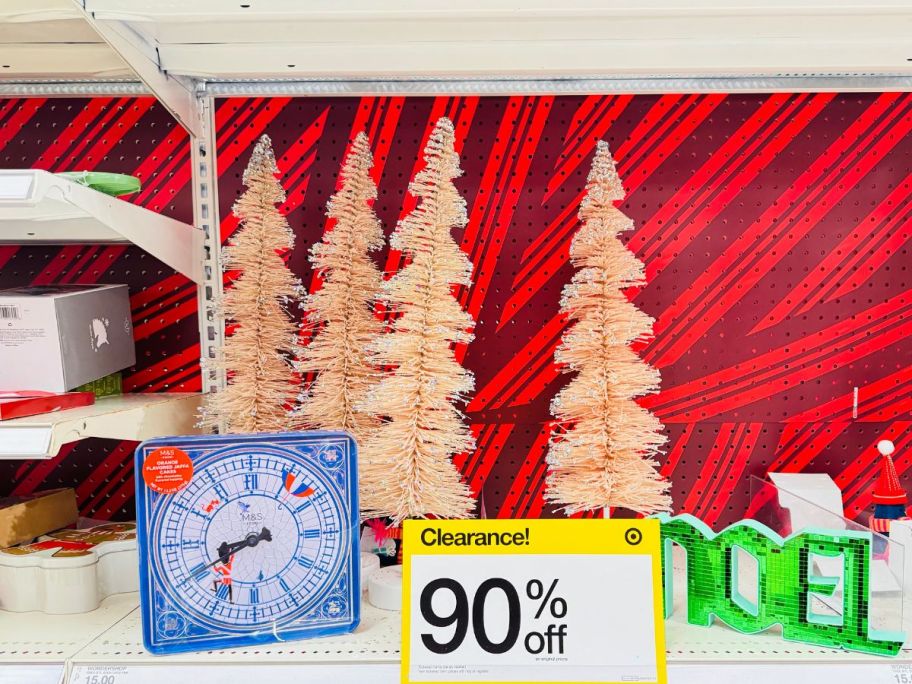 bottle brush trees and other decor on a store shelf