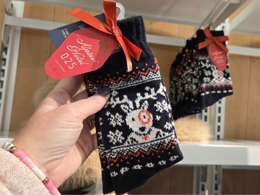 hand holding target bullseye holiday socks in store