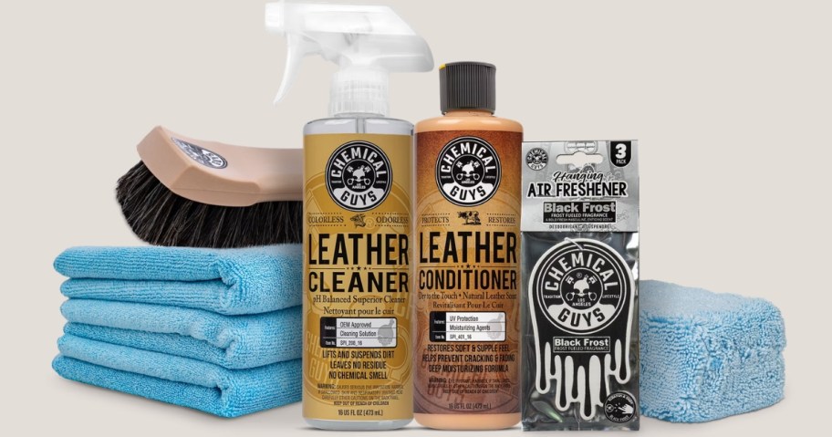 a leather care cleaning kit with towels, brush, and cleaning bottles