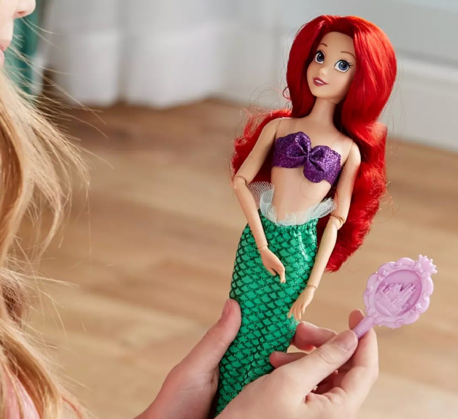 Girl holding an Ariel doll