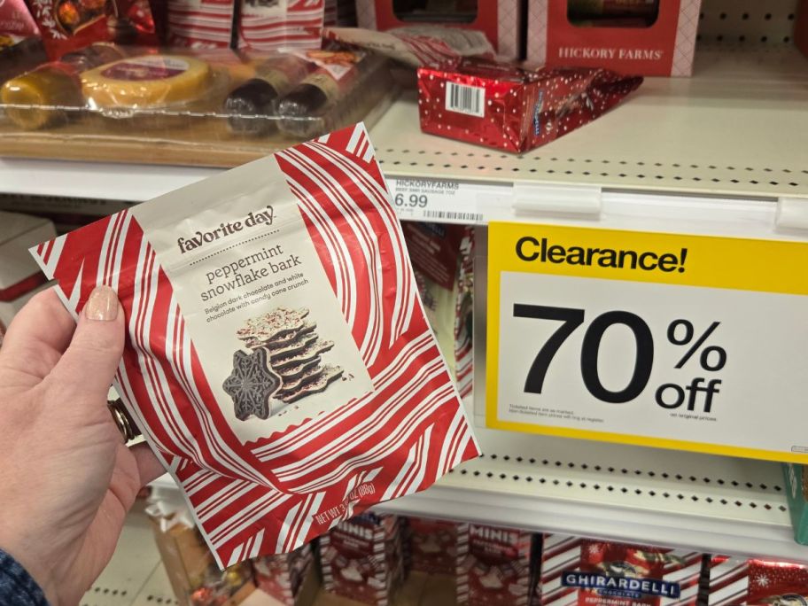 womans hand holding a bag of peppermint bark