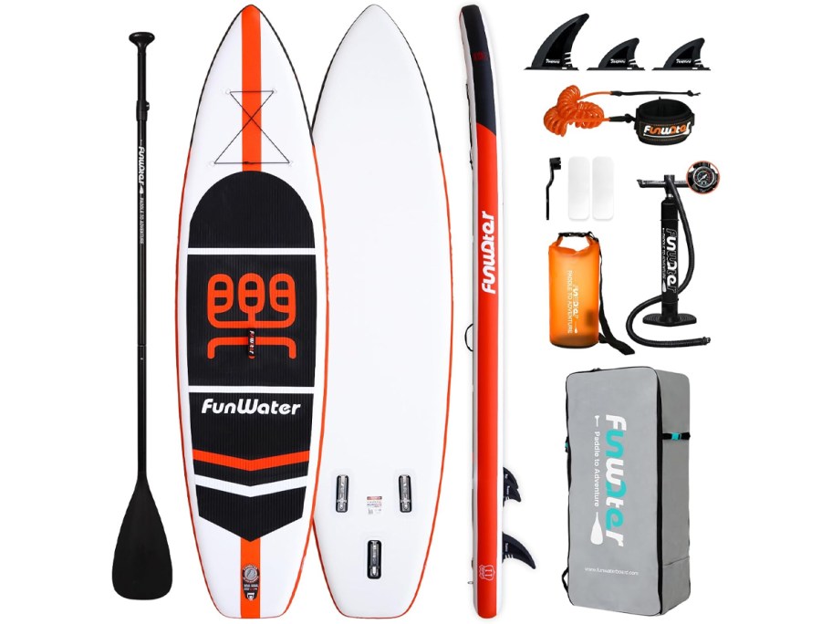 White and orange paddle board with accessories 