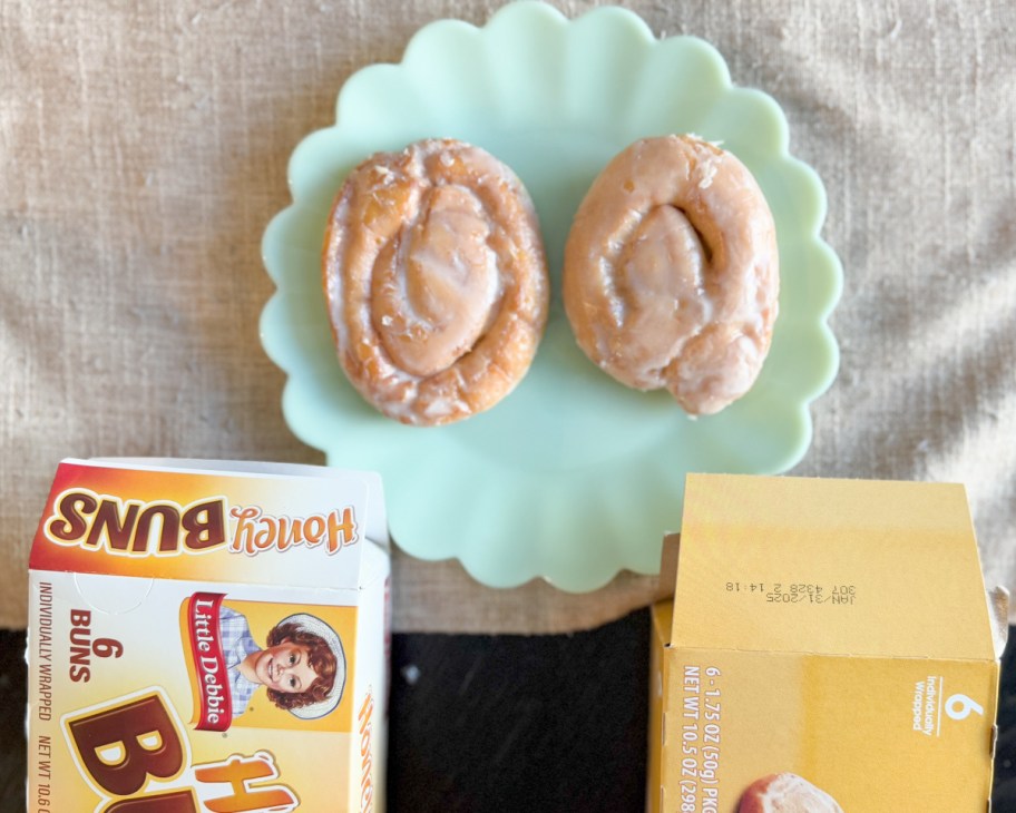 two honey buns on green plate