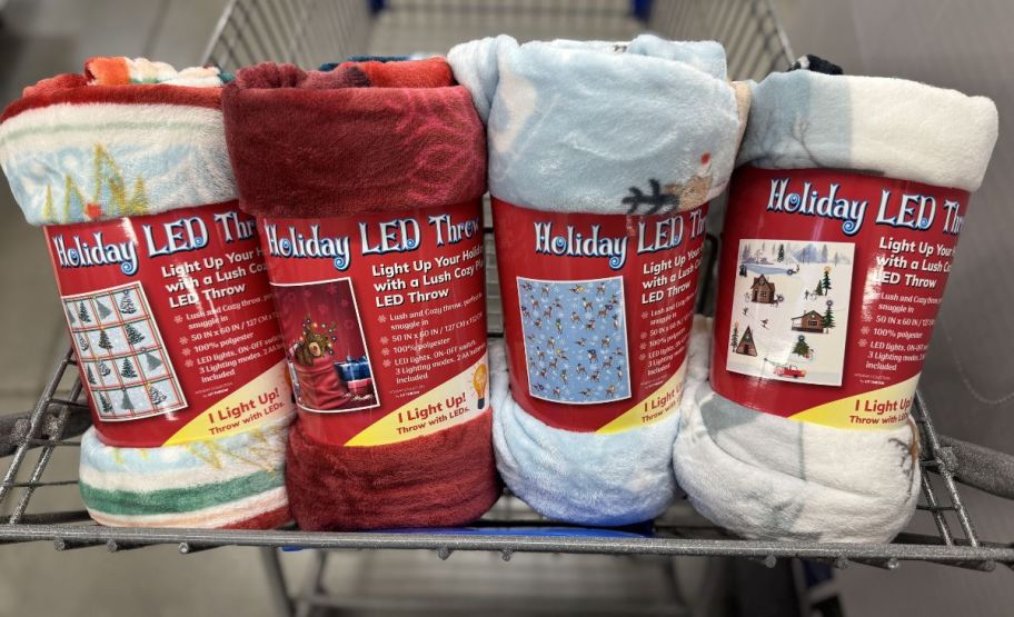 4 rolled up led holiday throws in a shopping cart