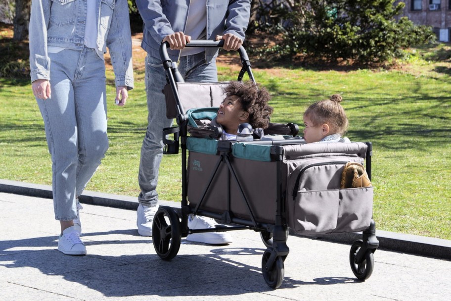 toddlers being pushed in a jeep stroller wagon