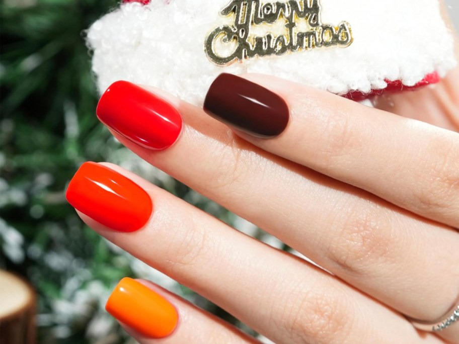 hand with christmas press on nails 