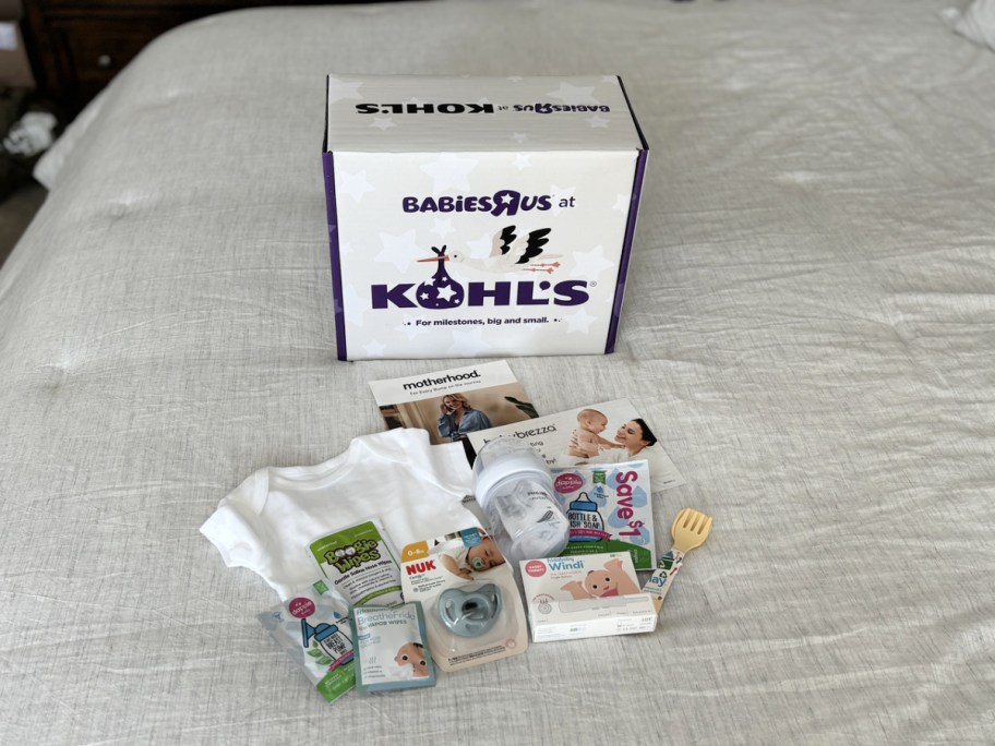 kohl's baby registry box and contents on a bed