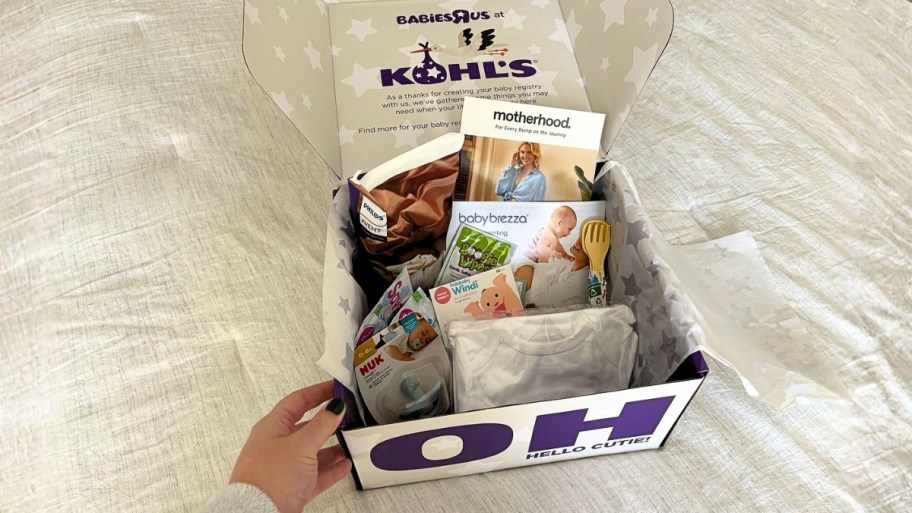 KOHLS BABY BOX OPEN AND ON A BED
