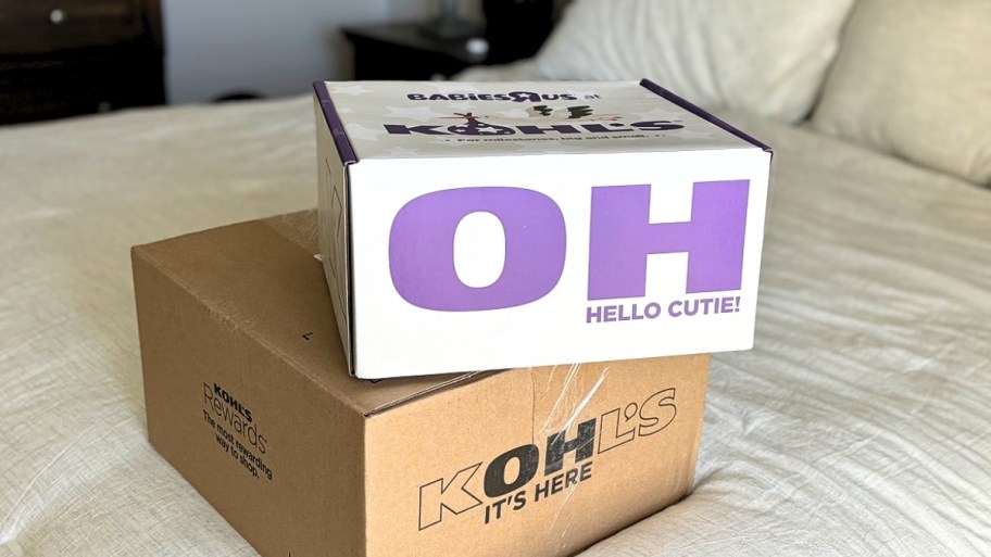 TWO KOHLS SHIPPING BOXES ON A BED