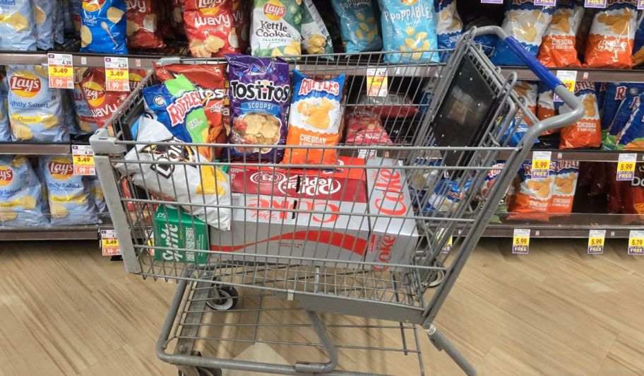 soda and chips inside a kroger shopping cart in store aisle