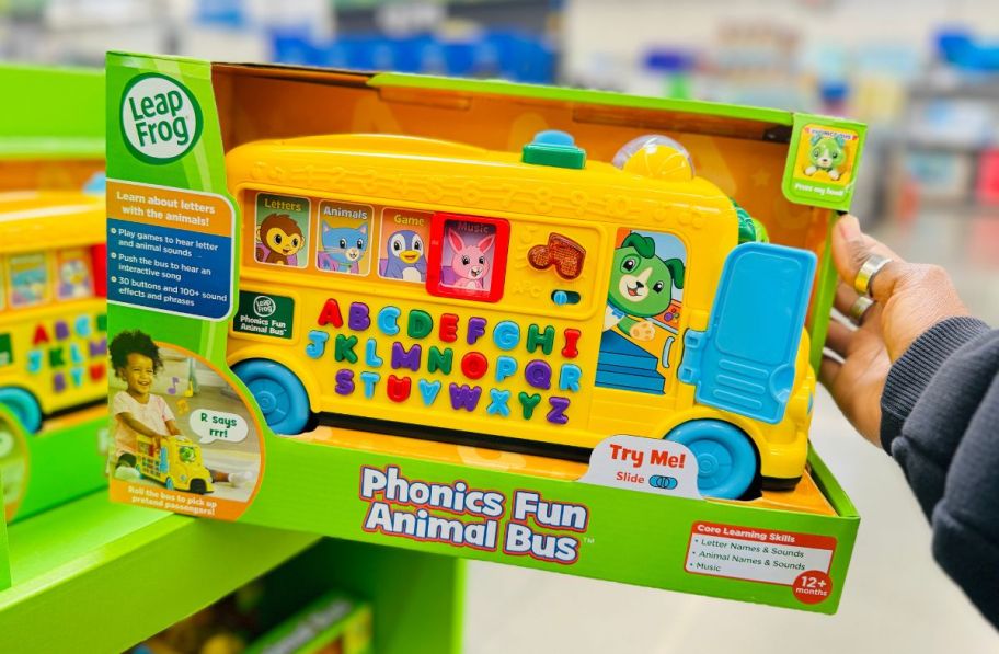 a womans hand holding a leapfrog phonics bus packaged instore