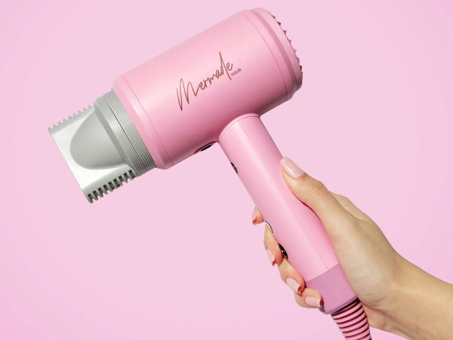 hand holding pink mermade blow dryer