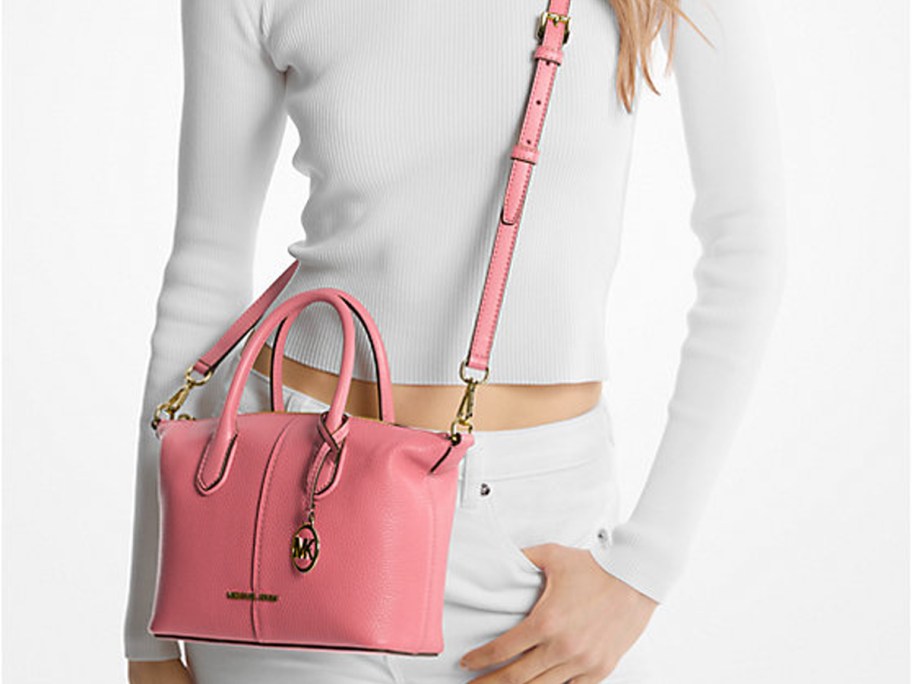 woman wearing pink bag and white tee