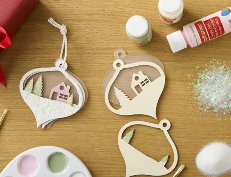 ornaments on table with pink and green pastel paint